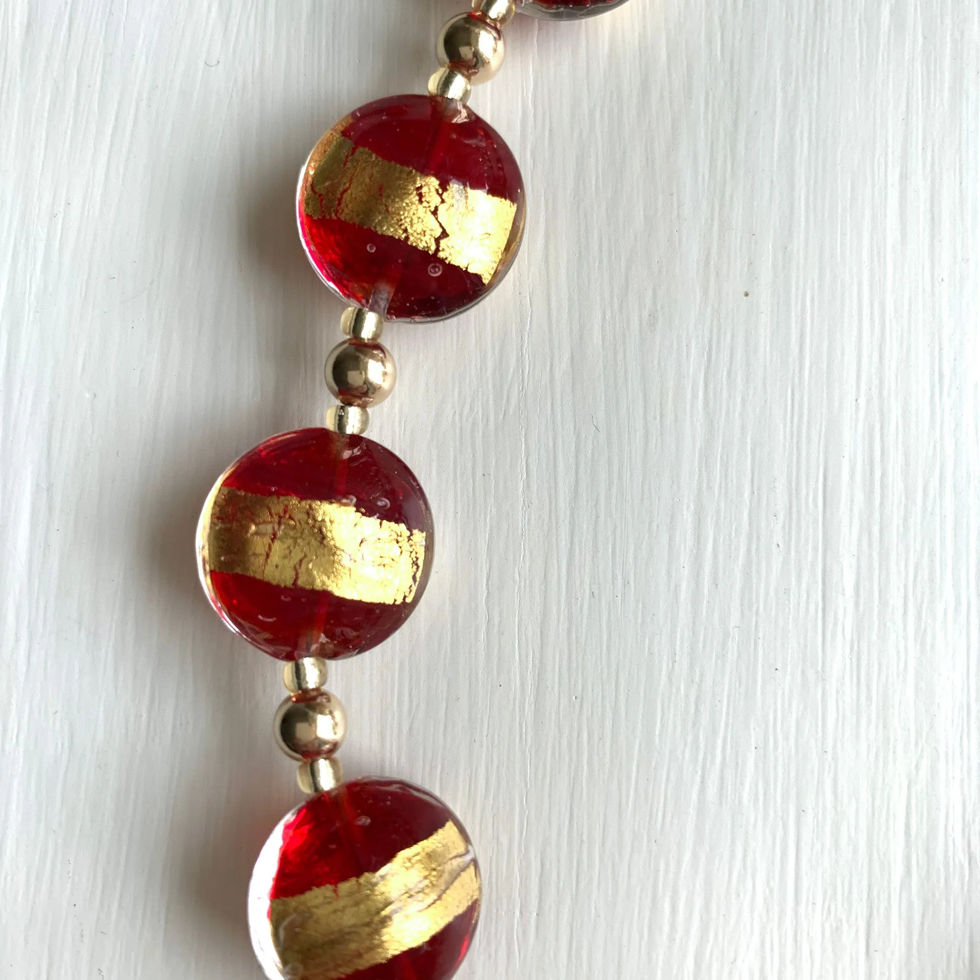 Necklace with red translucent and gold Murano glass medium lentil beads on gold